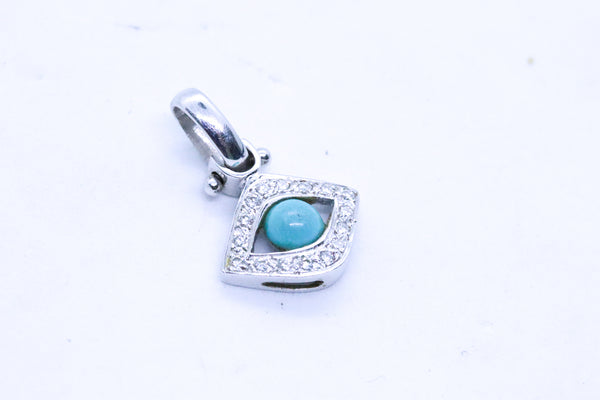 EYE OF HORUS CHARM 18 KT WITH DIAMONDS AND TURQUOISE