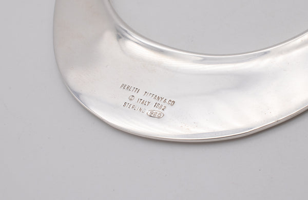 TIFFANY & CO. 1982 BY ELSA PERETTI, FLYING SAUCER OVAL BRACELET-PENDANT IN STERLING SILVER.