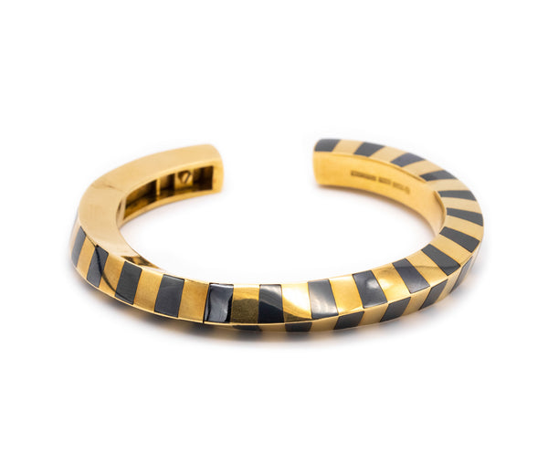 ANGELA CUMMINGS 1970'S FOR TIFFANY & CO. 18 KT GEOMETRIC BANGLE WITH HEMATITE