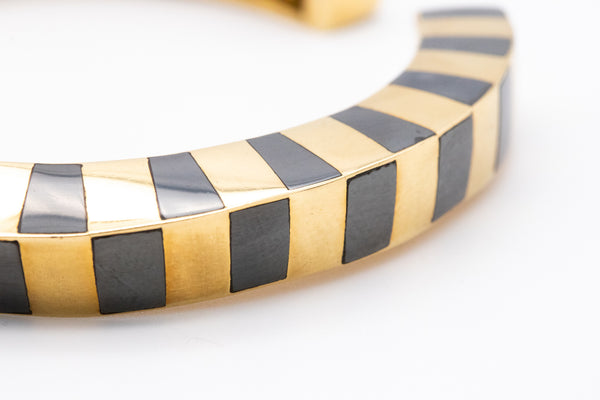 ANGELA CUMMINGS 1970'S FOR TIFFANY & CO. 18 KT GEOMETRIC BANGLE WITH HEMATITE