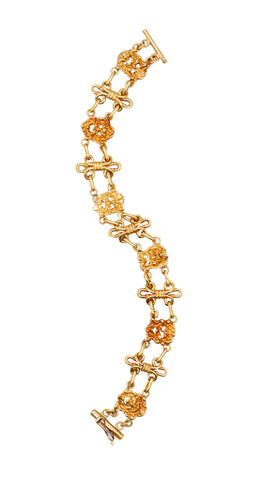 GERMANO, NINO D'ANTONIO 18 KT GOLD CHAINED BRACELET WITH THEATER FACES MEDALLION