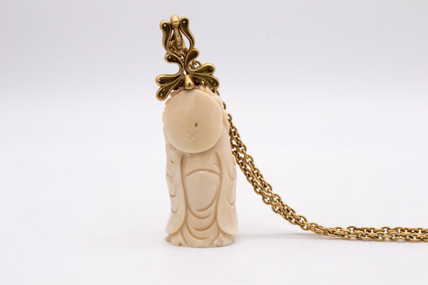 *Donald Huber 18 kt yellow necklace with standing Buddha in coral and 1.06 cts diamonds