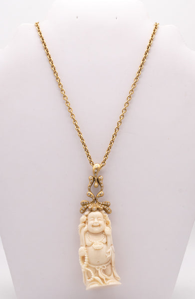 *Donald Huber 18 kt yellow necklace with standing Buddha in coral and 1.06 cts diamonds