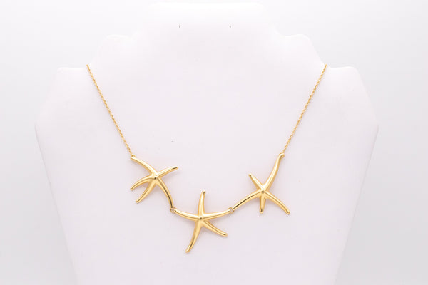 *Tiffany & Co. 1980's by Elsa Peretti 18 kt yellow gold necklace chain with three starfish