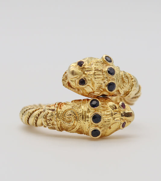 *Lalaounis 1970 Chimeras Lions Heads crossover Ring in 18 kt gold with Sapphires & Rubies