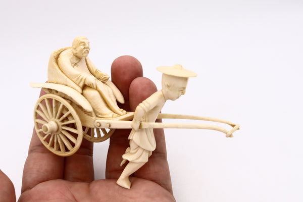 CHINA 1920 CHINESE CARVED MINIATURE OF A DOUBLE WHEELS CARRIAGE WITH RIDERS